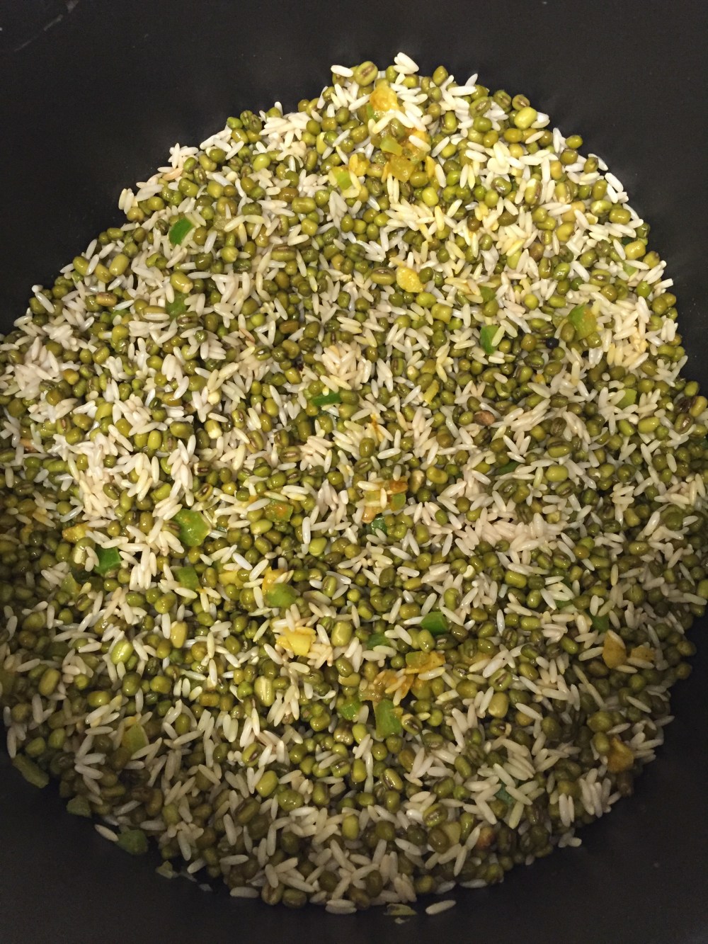 Add in spices and rice and mung beans